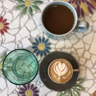 Tea, water, cortado with oat milk on custom-made, mosaic tile table