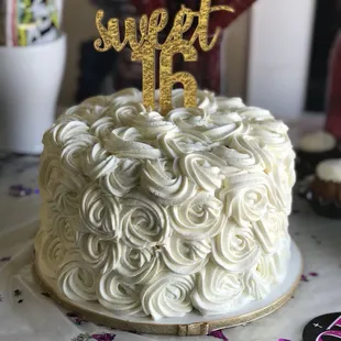 a white cake with a gold cake topper