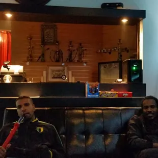 two men sitting on a couch
