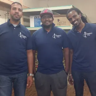 three men in blue shirts