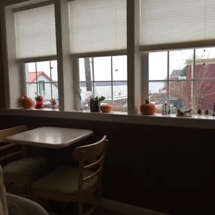 a table and chairs in front of a window