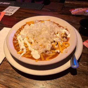 a bowl of chili and cheese