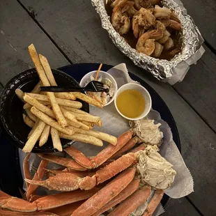 a plate of crab legs and fries