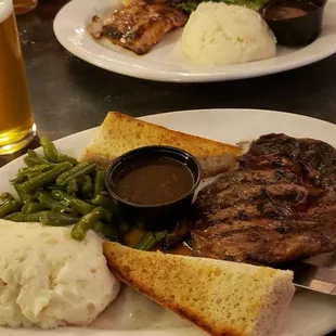 Rib eye steak mashed potatoes green beans and gravy