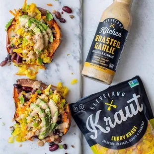 two stuffed sweet potatoes and a bottle of mustard