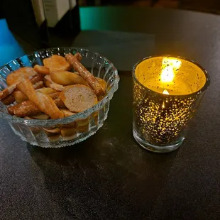 a bowl of fries and a lit candle