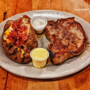 The pork chop, perfectly seared, a culinary delight. The potato? A crispy cocoon with a fluffy heart. Heaven on a plate!