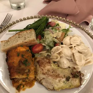 Lasagna, Mac &amp; cheese, salad, chicken, and broccolini I think?