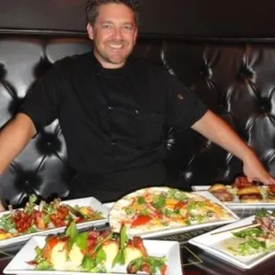 a man sitting at a table full of food
