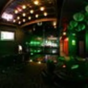 a view of a bar with green lights