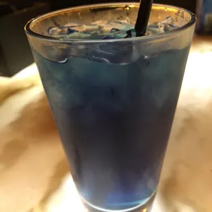 a blue drink with a straw
