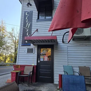 Side entrance, pretty close to the road. Building backs up to a cliff.