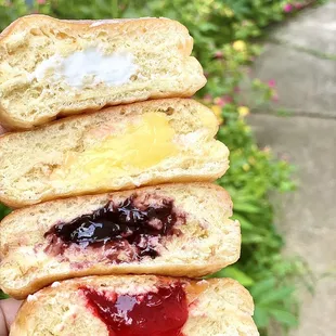a stack of donuts with jam and jelly