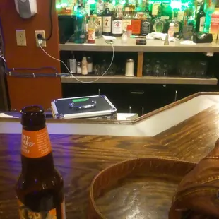 a bottle of beer on a bar counter
