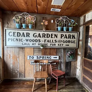 a chair in front of a sign for cedar garden park