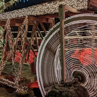 a spinning wheel with christmas lights in the background
