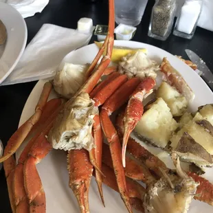 crab legs and potatoes on a plate