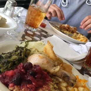 a man sitting at a table with a plate of food