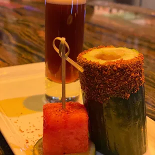 a glass of beer and a plate of food