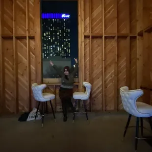 a man sitting at a table in front of a window