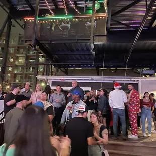 a large group of people standing in a building