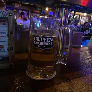 a glass of beer on a bar