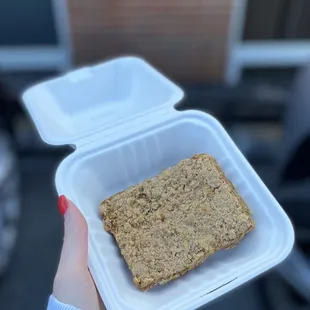 a piece of bread in a styrofoam container