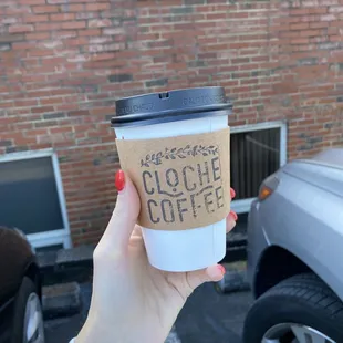 a woman holding a cup of coffee