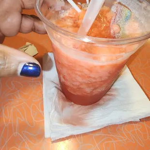 a drink being poured into a cup