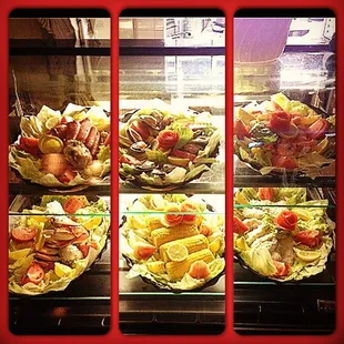 a variety of salads in a display case