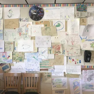 a wall full of children's drawings