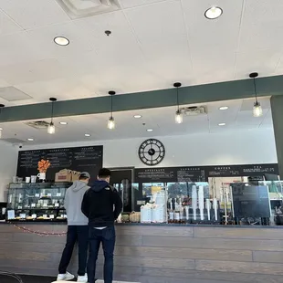two people standing at the counter