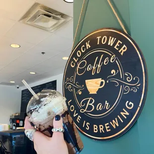 a hand holding a cup of coffee