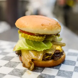 a cheeseburger on a checkered table