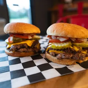 two burgers on a checkered table