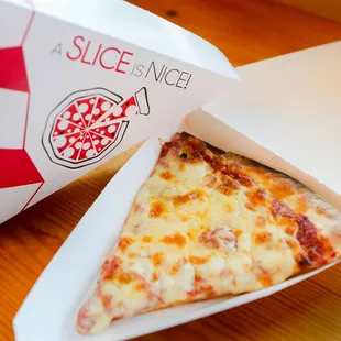 a slice of pizza in a box