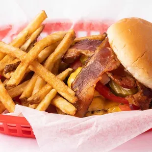 a basket of fries and a bacon sandwich