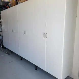 Garage cabinets, in white. Disregard the funky bright shadows in the last cabinets, it's just a reflection with my phone camera!