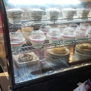 a display case filled with cupcakes