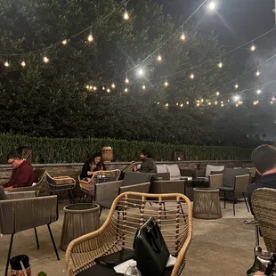 people sitting at tables outside at night