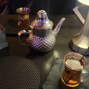 a table with a tea pot and a cup of tea