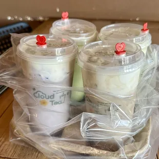 four cups of iced coffee on a table