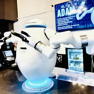 a robot holding a tea kettle