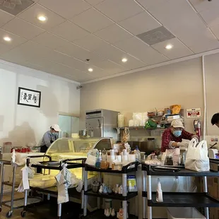 a restaurant kitchen with workers in the background