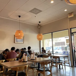 people sitting at tables in a restaurant