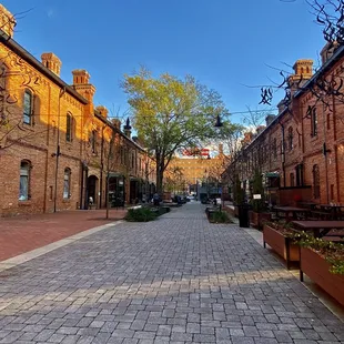 a cobblestone street lined with brick buildings