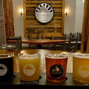 a row of beer glasses on a table