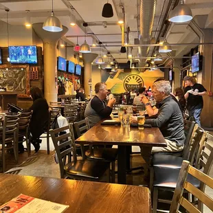 people sitting at tables in a restaurant