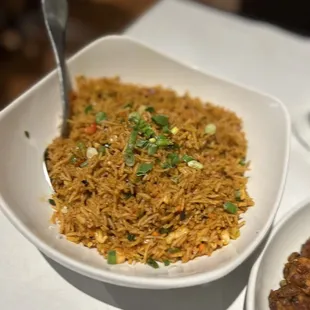 a bowl of rice and a plate of food