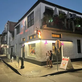 people standing outside of a restaurant